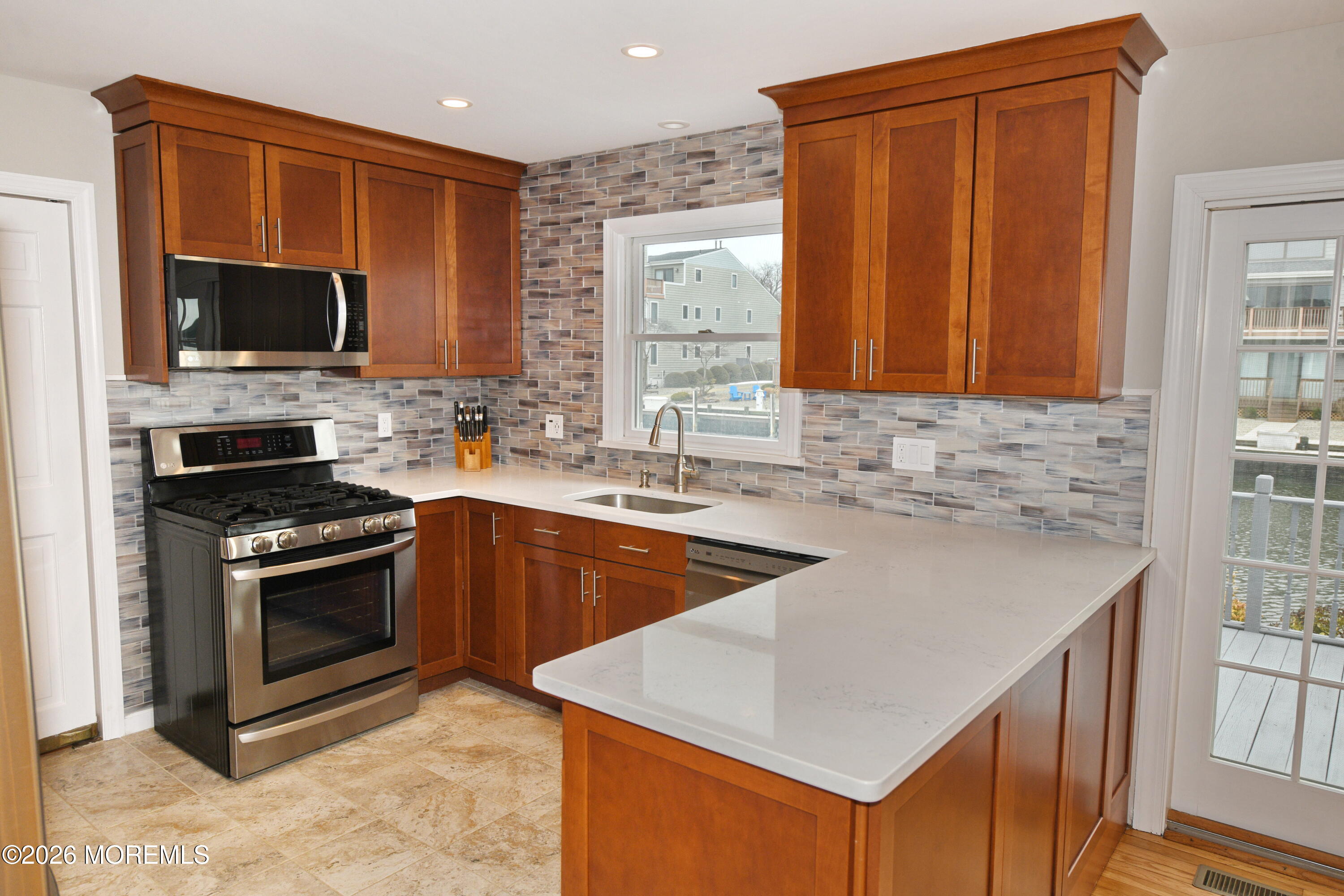 1608 Osprey Court Point Pleasant, NJ 08742 - Photo 8 of 40 a kitchen with stainless steel appliances granite countertop a sink stove and microwave