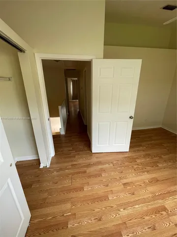 a view of a hallway to rooms