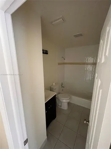 a bathroom with a sink a toilet and a shower
