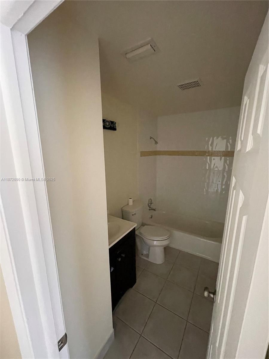 2880 Belmont Lane, Unit 2880 Cooper City, FL 33026 - Photo 12 of 16 a bathroom with a sink a toilet and a shower