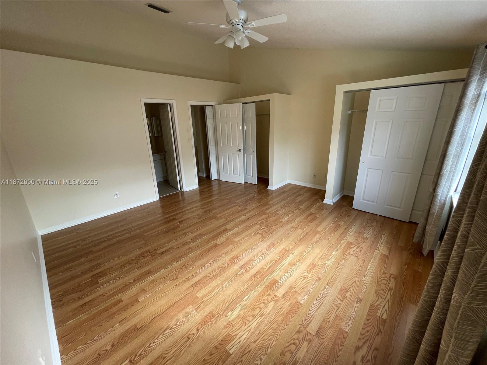 2880 Belmont Lane, Unit 2880 Cooper City, FL 33026 - Photo 13 of 16 a view of an empty room with wooden floor and a window