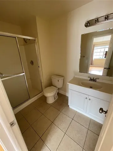 a bathroom with a sink a toilet a mirror and vanity