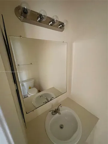 a bathroom with a sink and mirror
