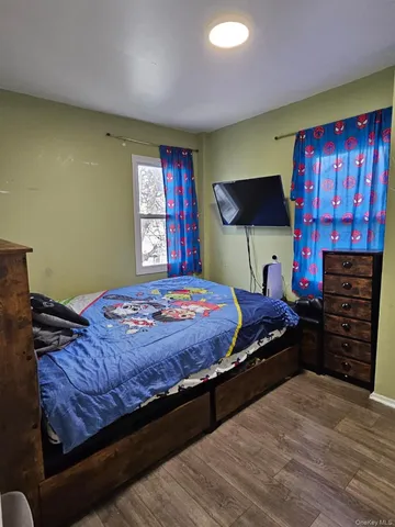 a bed sitting in a bedroom next to a window