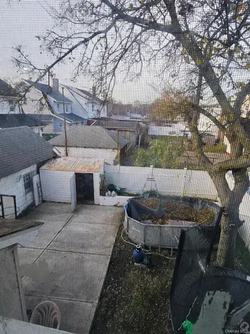 a view of a backyard with couches and a fire pit