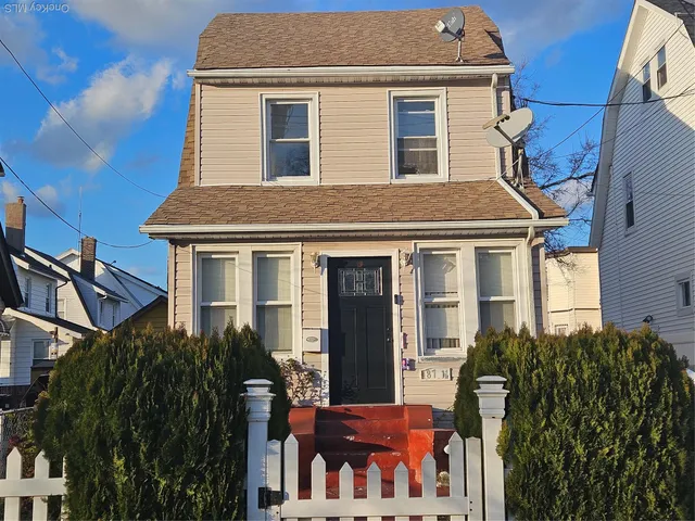 a view of a house with many windows and plants