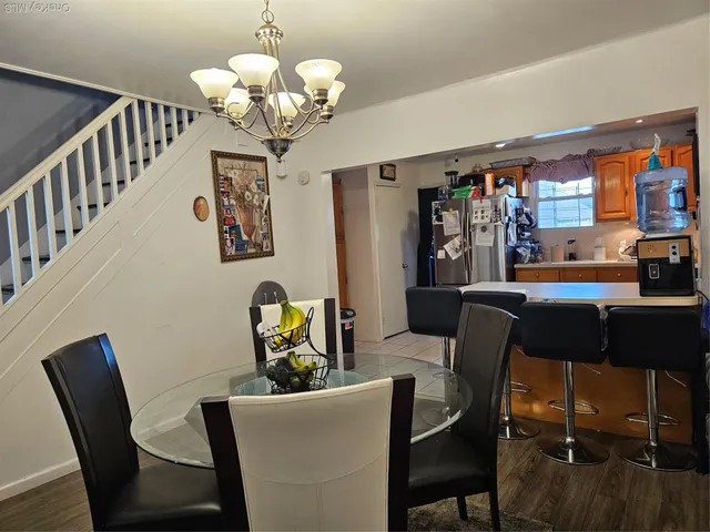 a dining room with furniture and chandelier