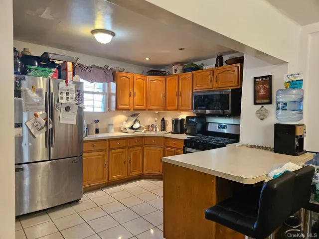 a kitchen with stainless steel appliances a refrigerator a stove a sink dishwasher and a refrigerator