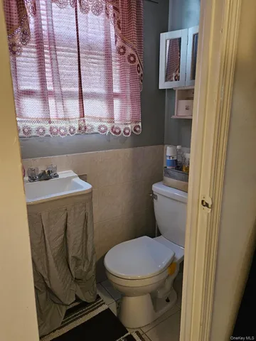 a bathroom with a toilet a sink and a window