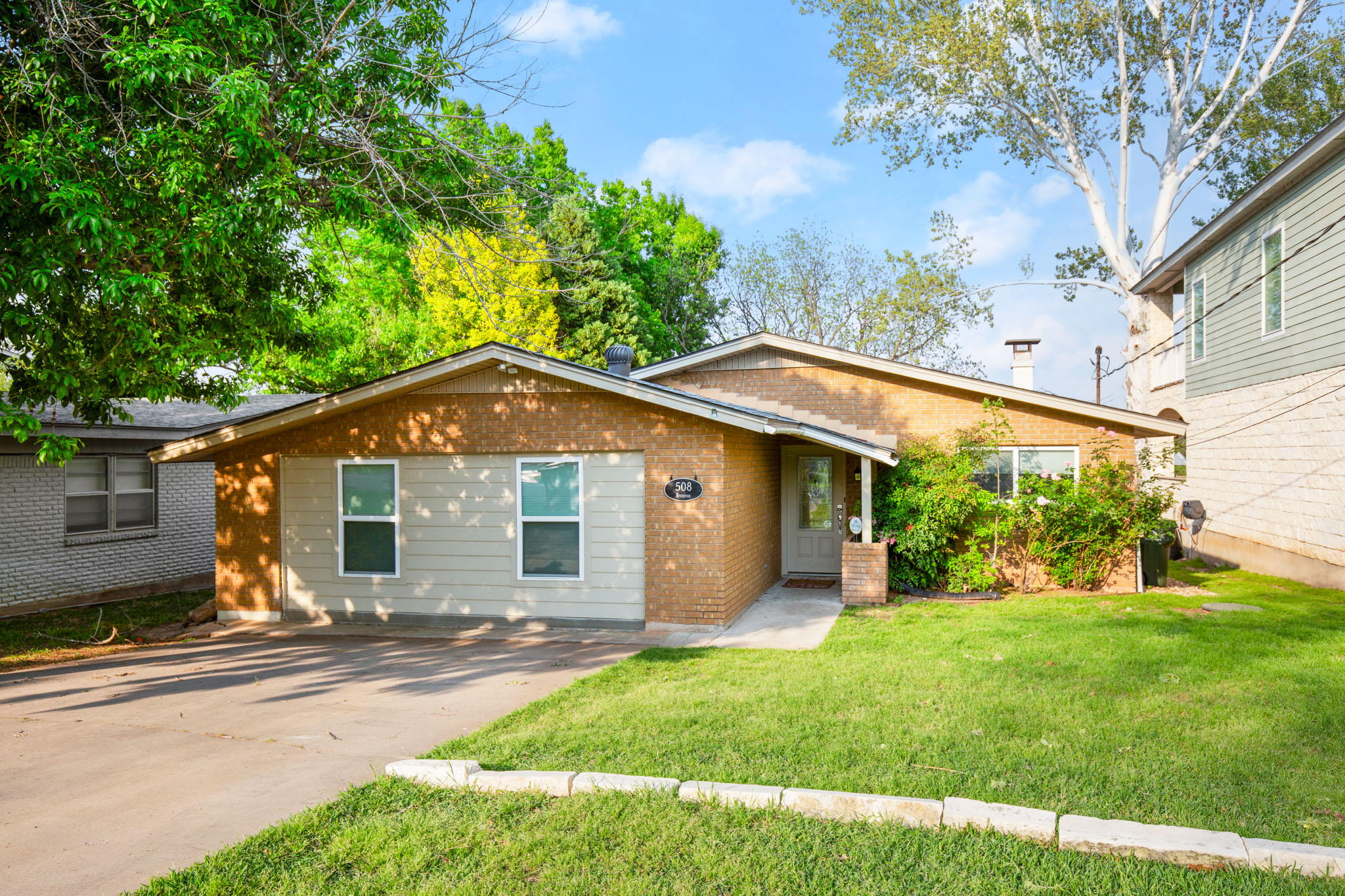 508 Riverside Drive Kingsland, TX 78639 - Photo 5 of 39 a view of a house with yard and a garden