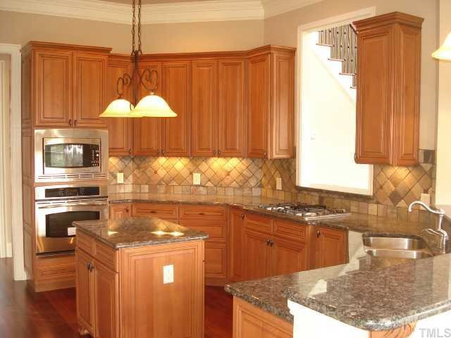 3308 Cotten Road, Unit LOT85 Raleigh, NC 27603 - Photo 5 of 12 Beautiful large kitchen with island, gorgeous granite & backsplash and pass-through to Family Room, gas burner cooktop & wall ovens. Large walk-in pantry. Kitchen