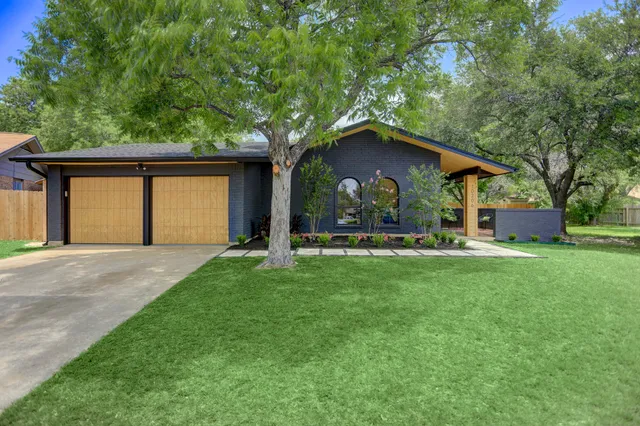 a front view of house with yard and green space