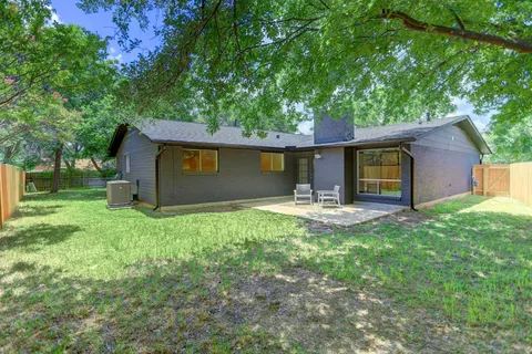 a backyard of a house with yard barbeque oven and outdoor seating