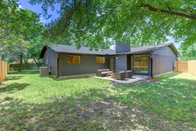 a view of a house with backyard porch and garden