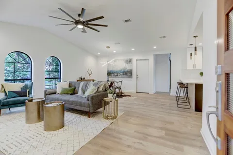 a living room with furniture gym equipment and a view of kitchen