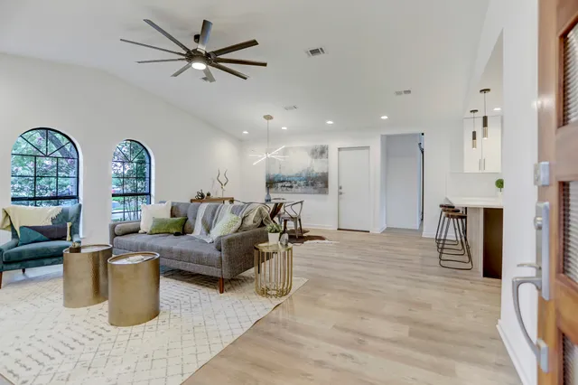 a living room with furniture gym equipment and a view of kitchen