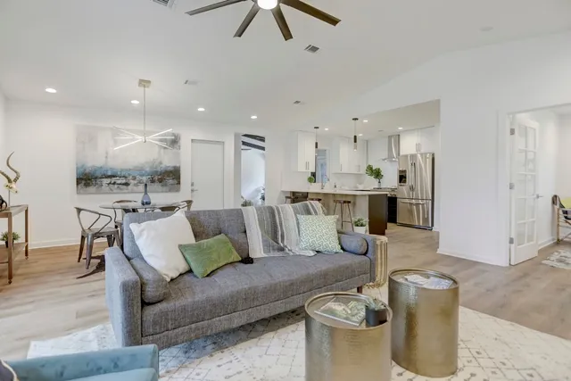 a living room with furniture and kitchen view