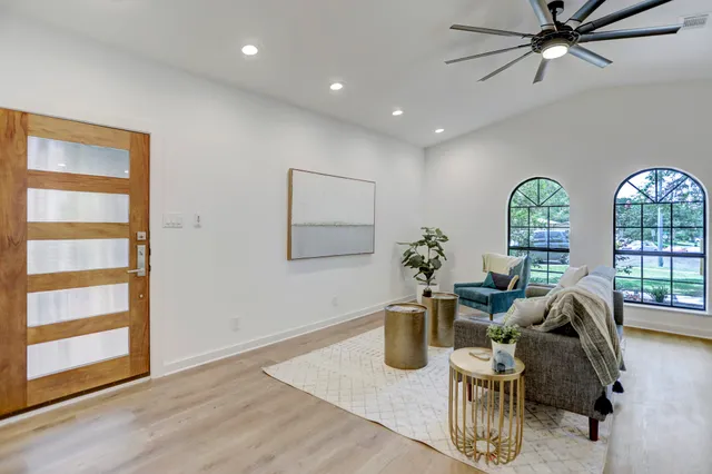 a view of a livingroom with furniture window and wooden floor