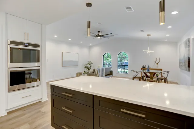 a view of a double vanity sink a microwave and a refrigerator
