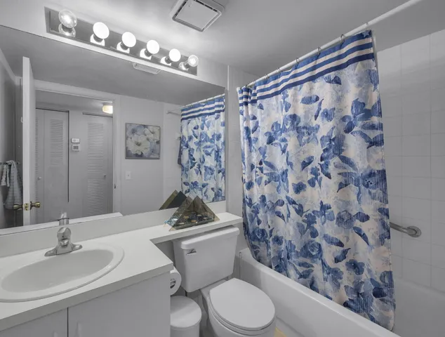 a bathroom with a toilet a sink and a mirror