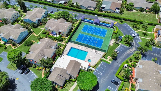 an aerial view of a house with a yard and outdoor seating
