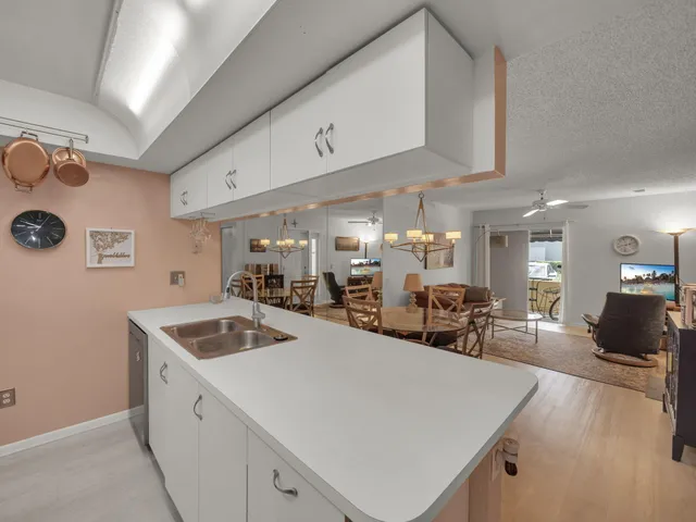 a kitchen with sink cabinets and chairs