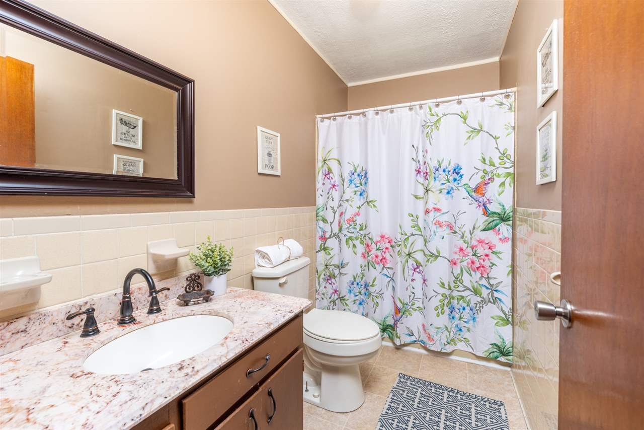 795 Purple Cow Road Waynesboro, VA 22980 - Photo 36 of 50 a bathroom with a granite countertop toilet sink and mirror