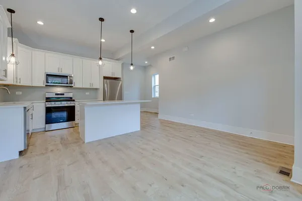 a view of a kitchen with a sink and a stove top oven