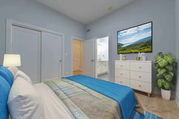 a bedroom with a bed and a dresser