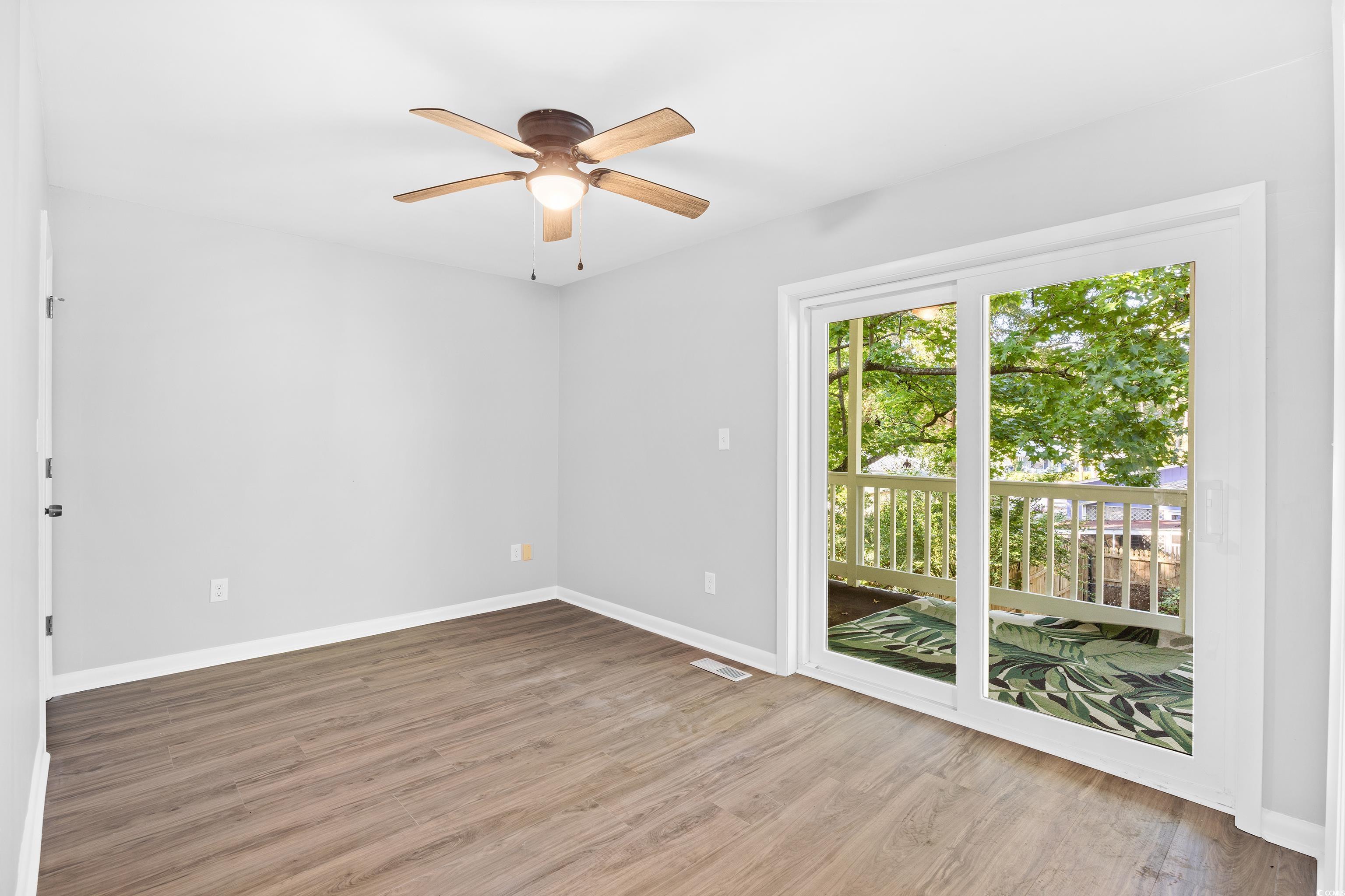 617 Surfside Drive Surfside Beach, SC 29575 - Photo 13 of 39 Spare room featuring light wood-style floors and ceiling fan