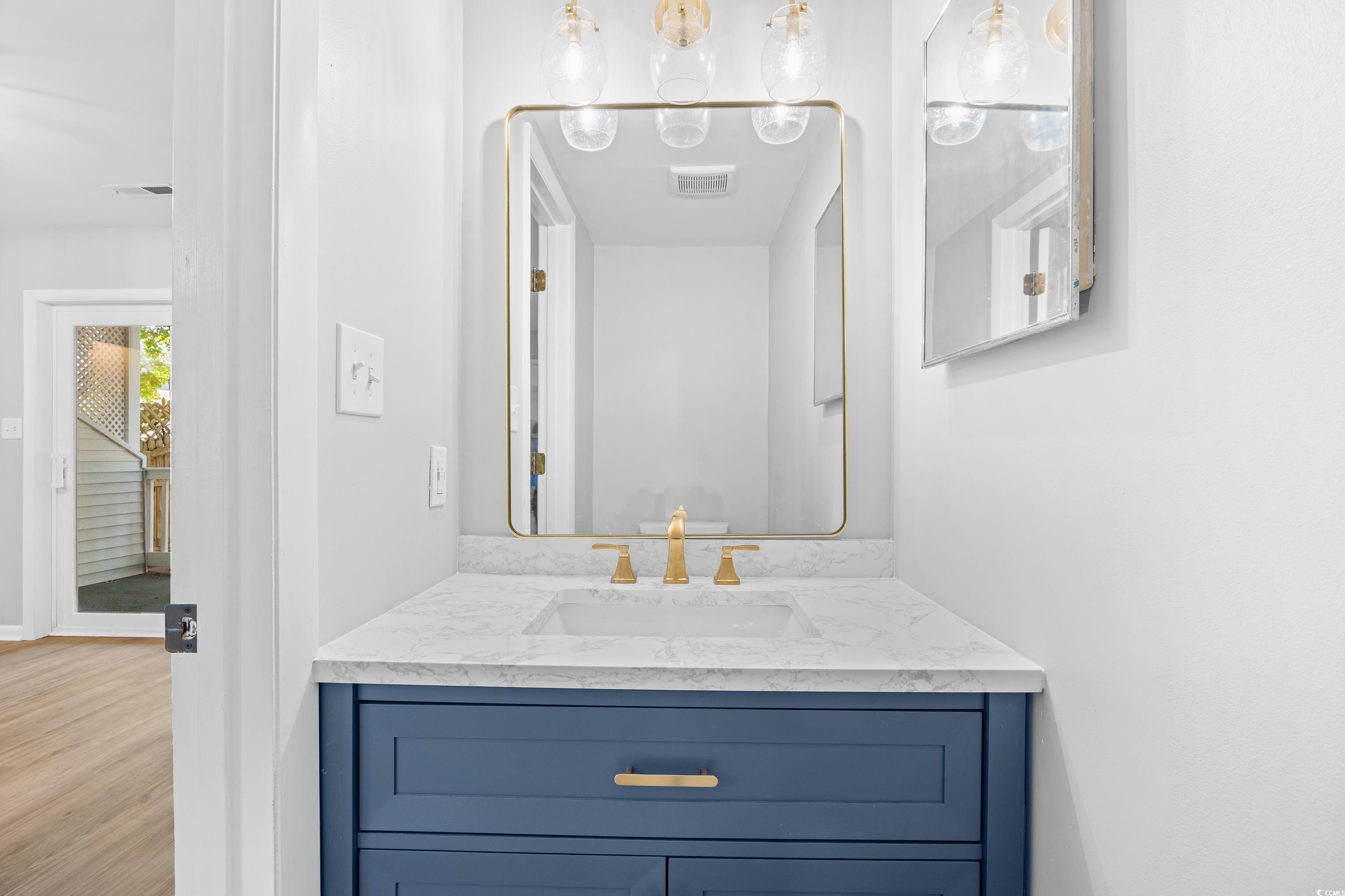 617 Surfside Drive Surfside Beach, SC 29575 - Photo 19 of 39 Bathroom featuring vanity and wood finished floors