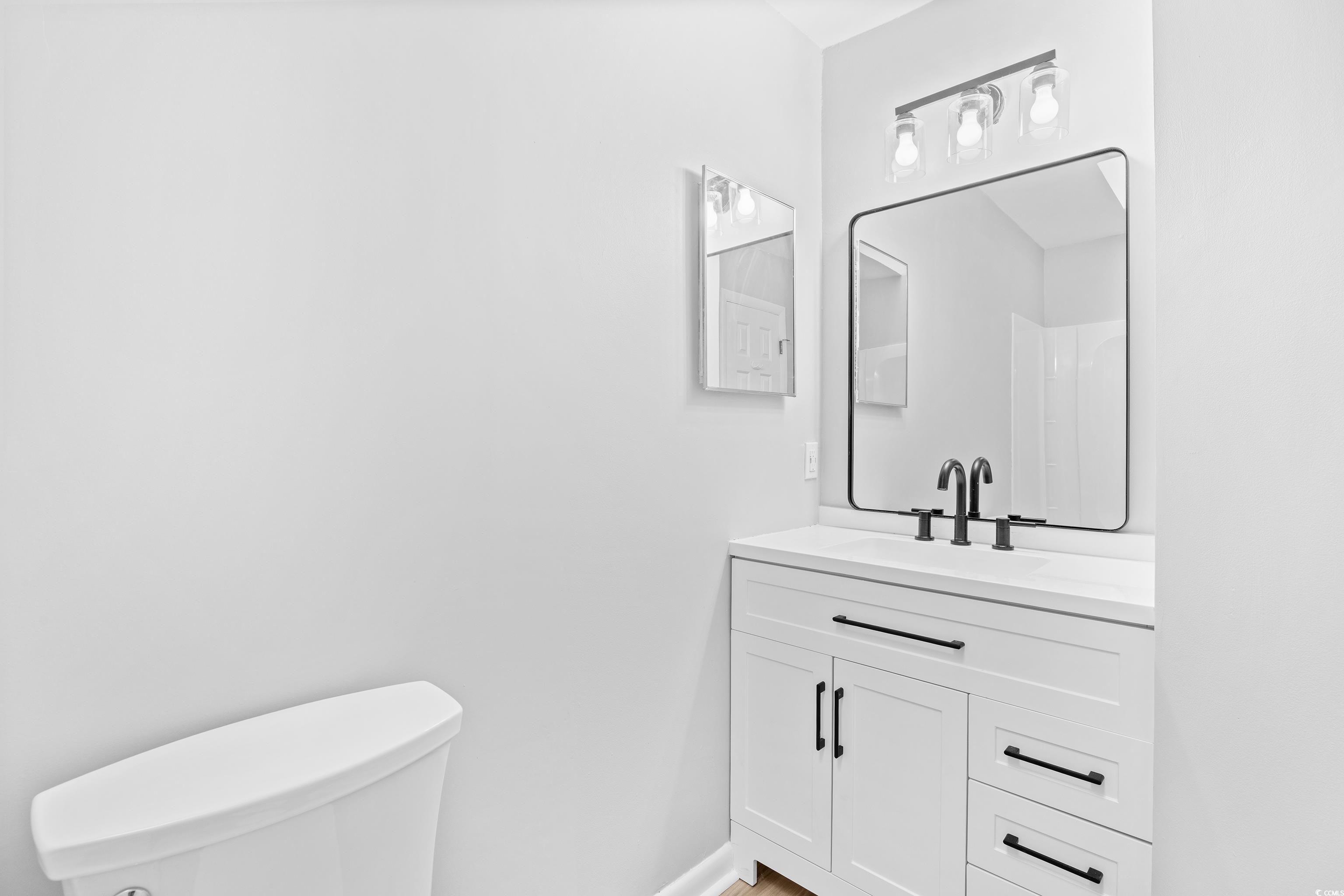 617 Surfside Drive Surfside Beach, SC 29575 - Photo 22 of 39 Half bath featuring vanity and toilet