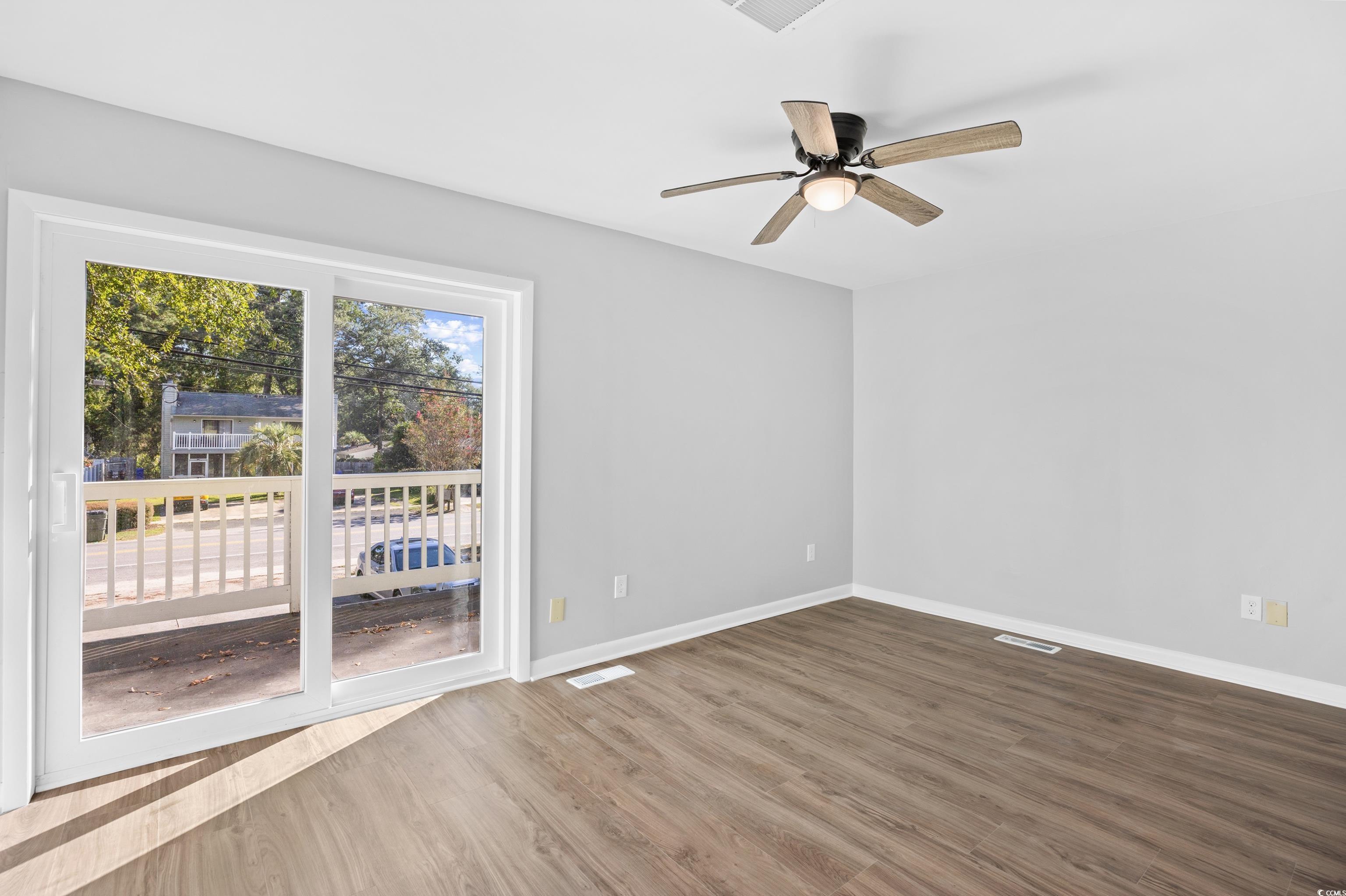 617 Surfside Drive Surfside Beach, SC 29575 - Photo 25 of 39 Empty room with wood finished floors and a ceiling fan
