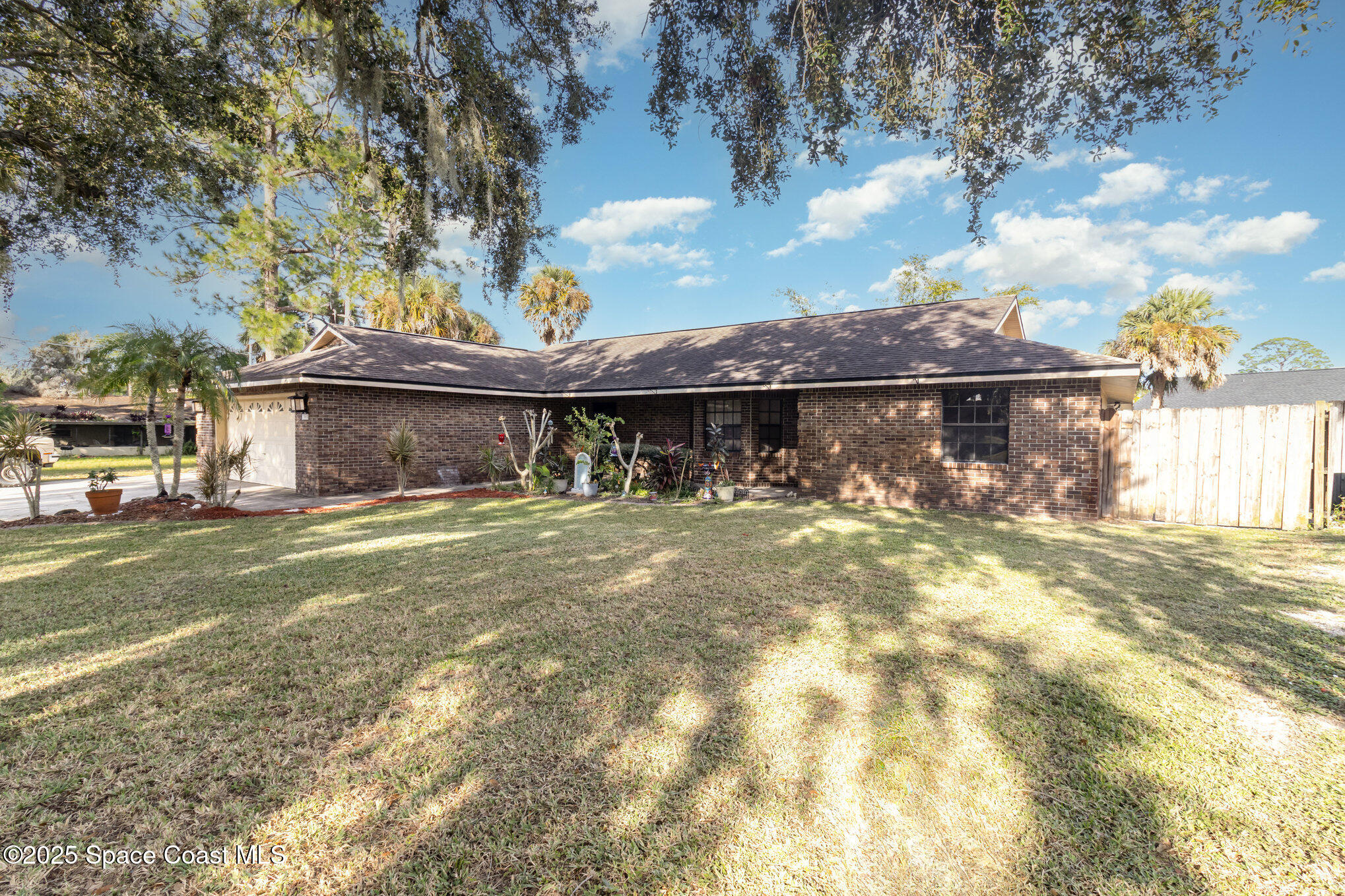 7065 Bright Avenue Cocoa, FL 32927 - Photo 3 of 12 a front view of a house with a garden