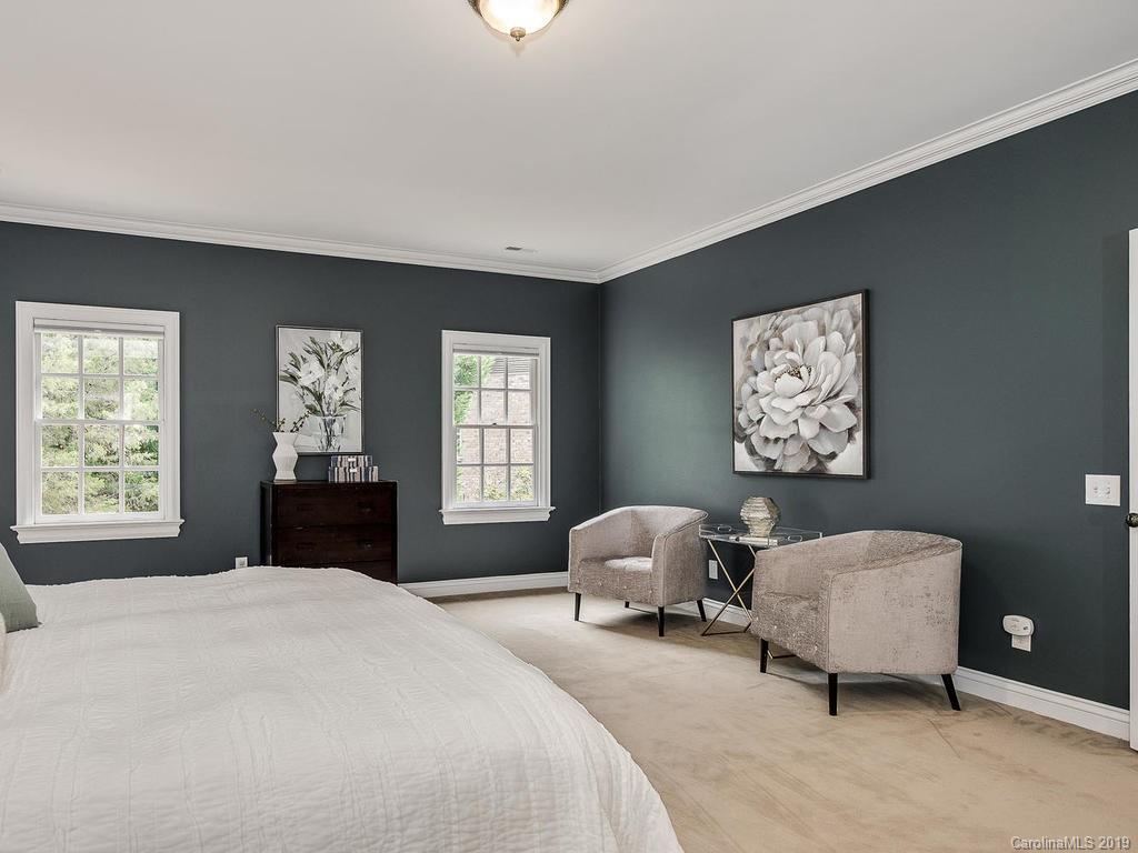 4501 Nora's Path Road Charlotte, NC 28226 - Photo 18 of 32 a spacious bedroom with a bed a couch and a window