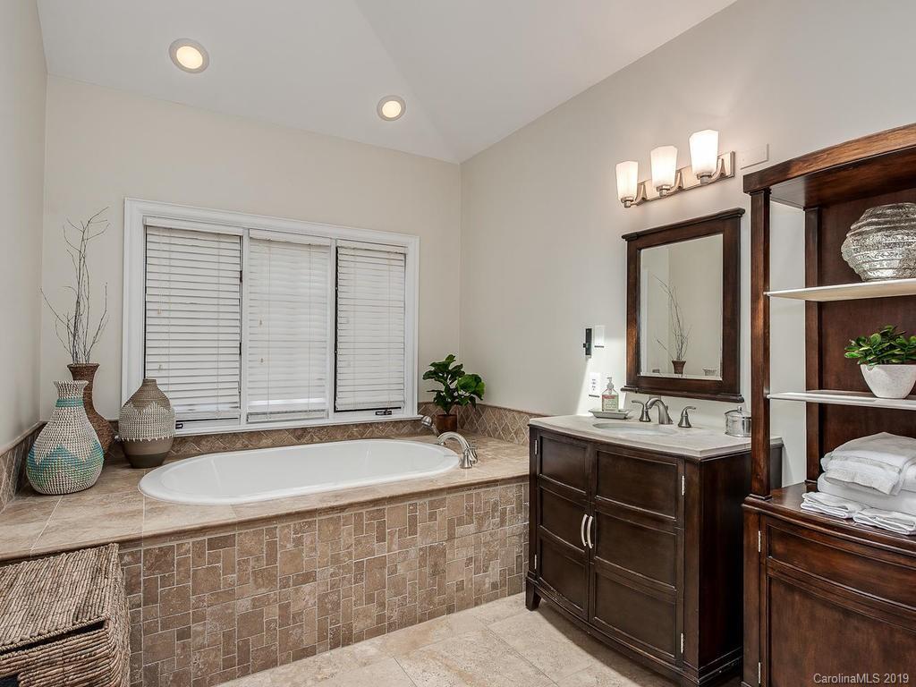 4501 Nora's Path Road Charlotte, NC 28226 - Photo 20 of 32 a spacious bathroom with a tub sink and mirror
