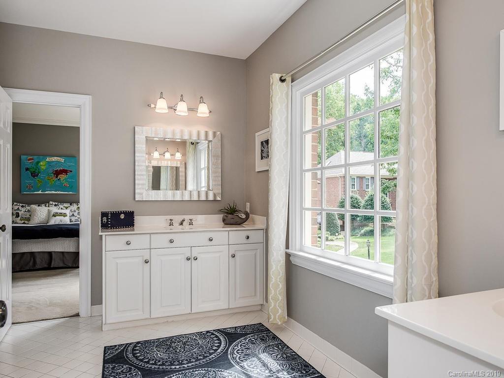 4501 Nora's Path Road Charlotte, NC 28226 - Photo 25 of 32 a spacious bathroom with a double vanity sink a mirror and a shower