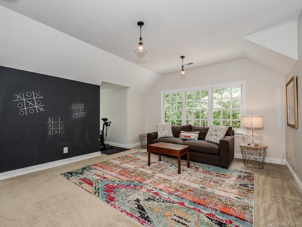 4501 Nora's Path Road Charlotte, NC 28226 - Photo 28 of 32 a living room with furniture and a rug