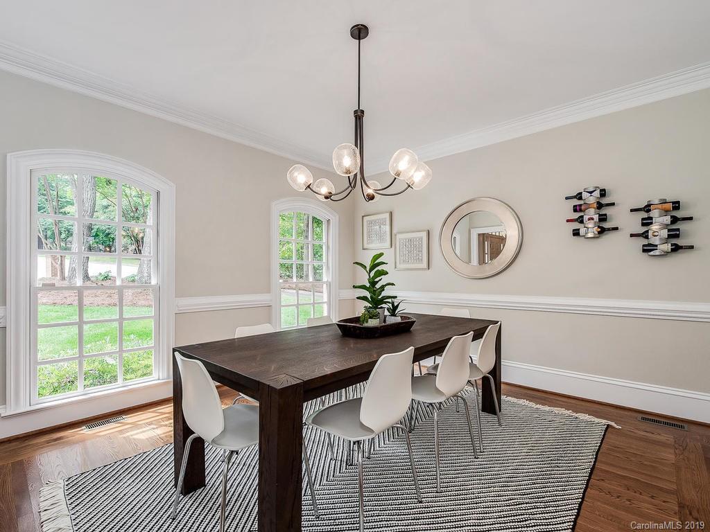 4501 Nora's Path Road Charlotte, NC 28226 - Photo 6 of 32 a dining room with wooden floor a chandelier a wooden table and chairs