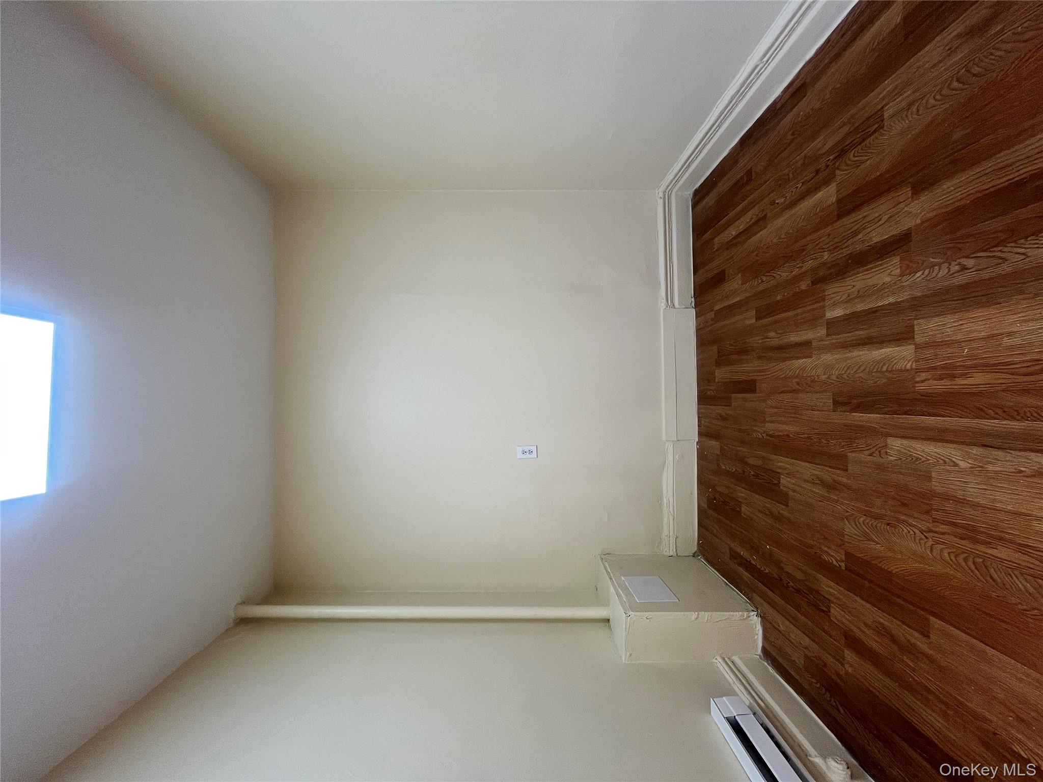 30 West Kingsbridge Road, Unit 3 Bronx, NY 10468 - Photo 11 of 14 a view of a room with wooden floor and white walls