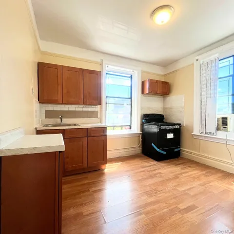 a kitchen with granite countertop a refrigerator and cabinets