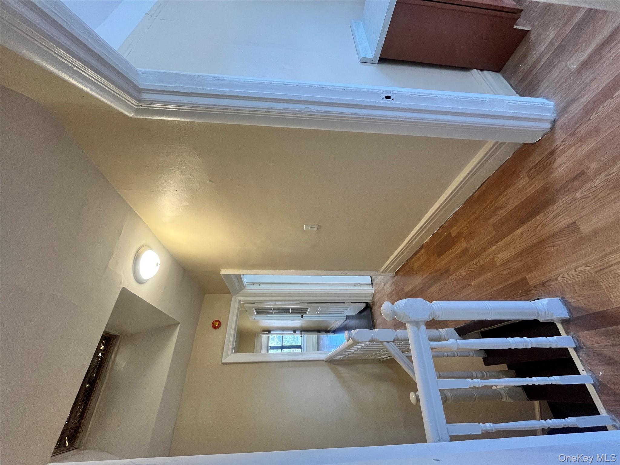 30 West Kingsbridge Road, Unit 3 Bronx, NY 10468 - Photo 14 of 14 a view of a hallway with wooden floor and staircase