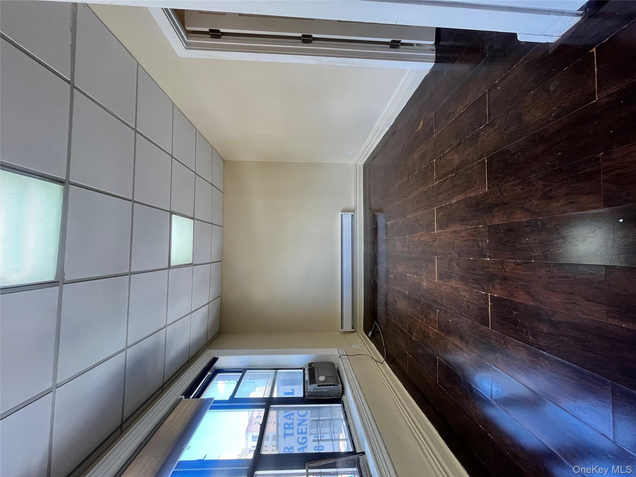 30 West Kingsbridge Road, Unit 3 Bronx, NY 10468 - Photo 4 of 14 an empty room with wooden floor and windows