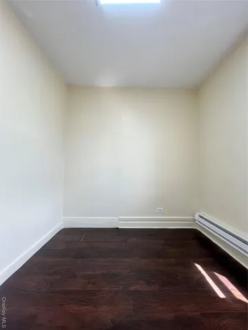 a view of an empty room and wooden floor