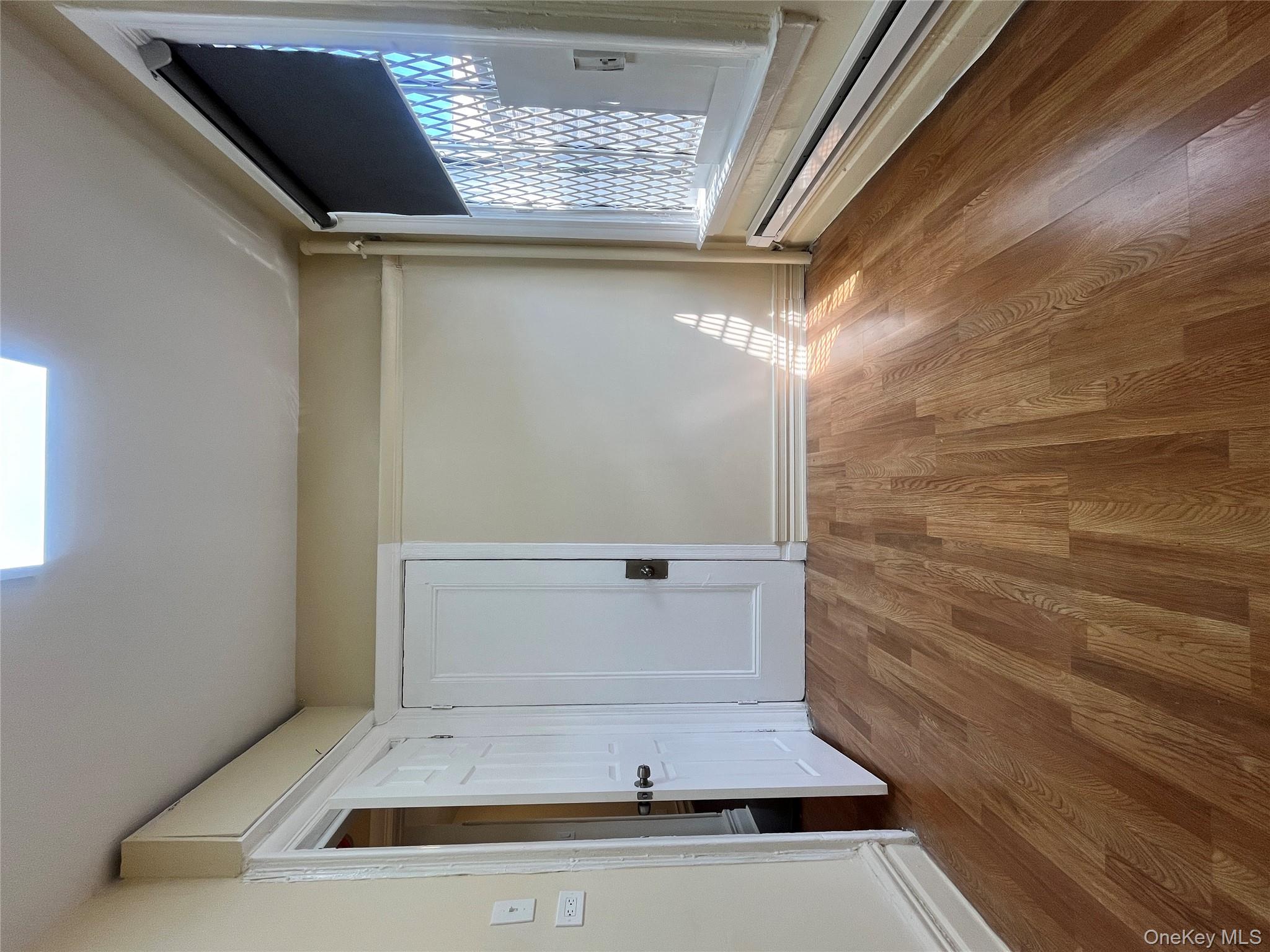 30 West Kingsbridge Road, Unit 3 Bronx, NY 10468 - Photo 10 of 14 a view of empty room with wooden floor and fan