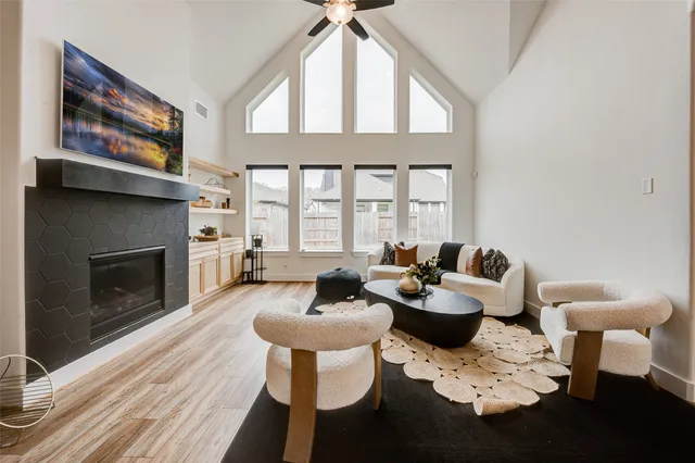 a dining room with furniture a fireplace and wooden floor