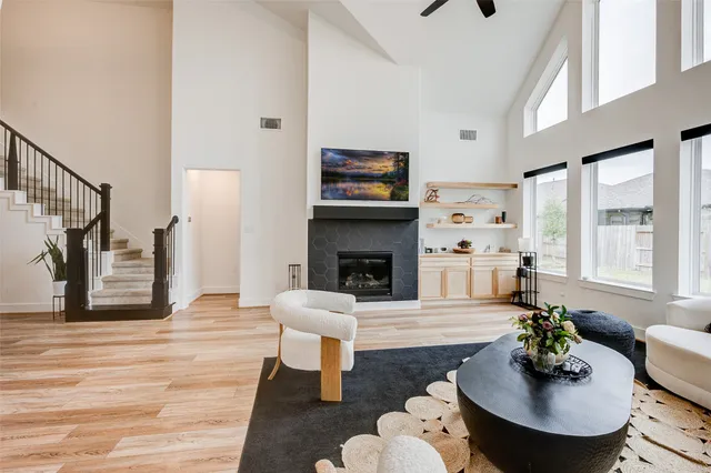 a living room with furniture a fireplace and a flat screen tv