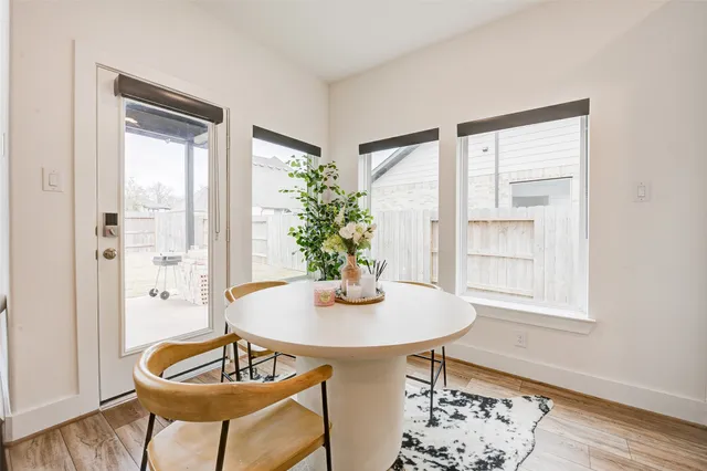 a view of a dining room with furniture window and wooden floor
