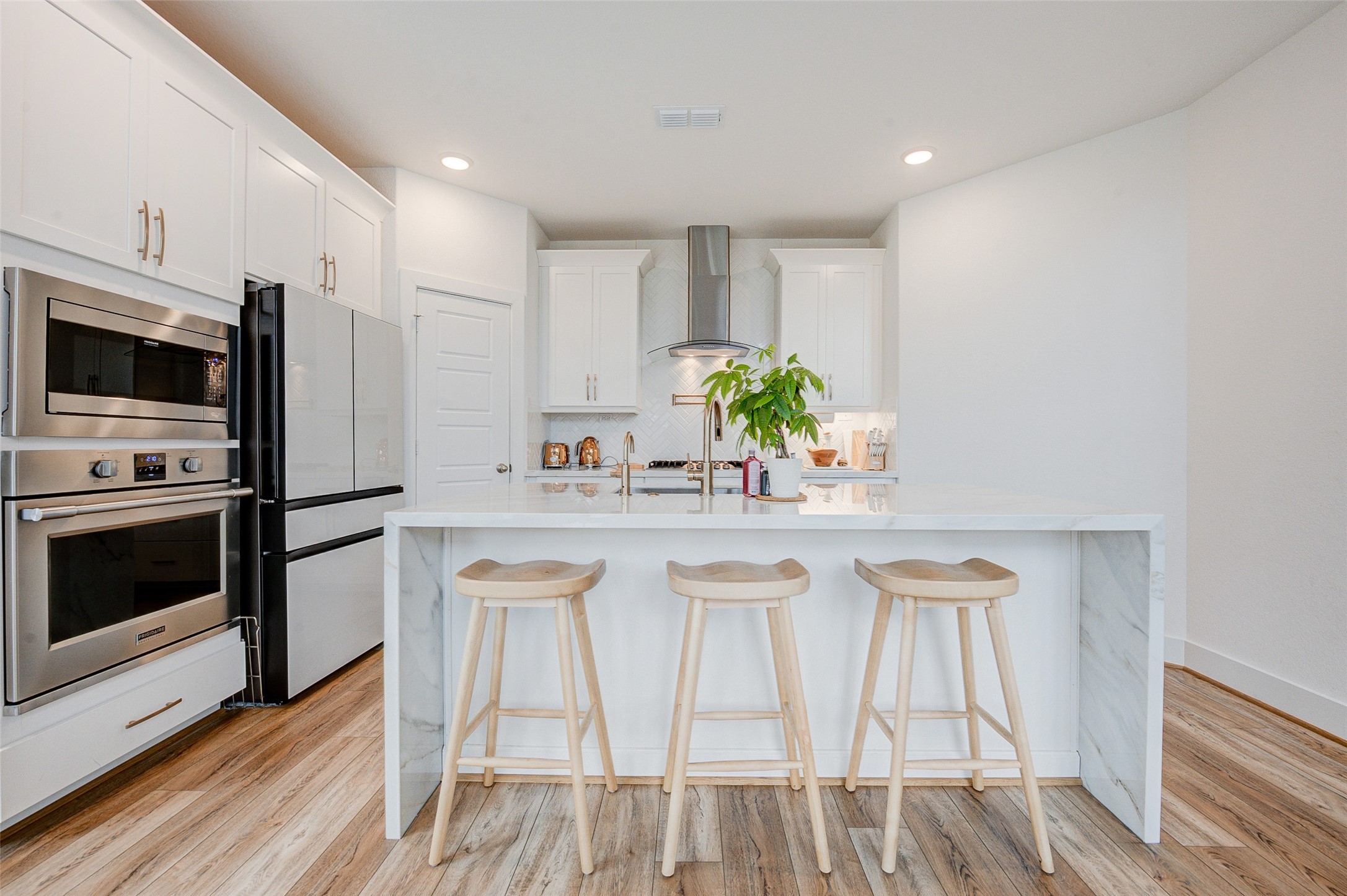 4606 Wax Myrtle Court Fulshear, TX 77441 - Photo 18 of 36 a kitchen with stainless steel appliances a microwave a stove a table and chairs