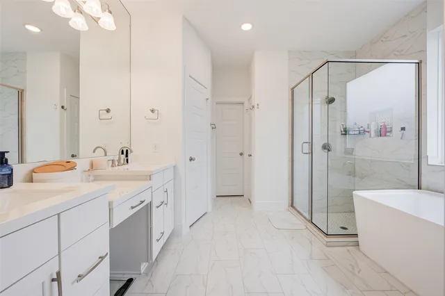 a bathroom with a double vanity sink toilet mirror and shower